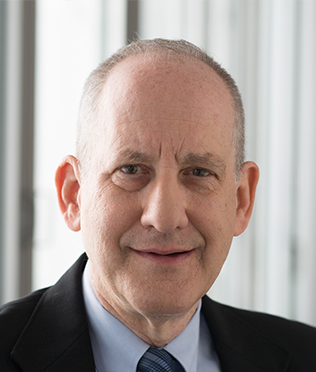 older man smiling in suit