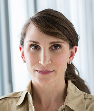 Headshot of woman in tan shirt