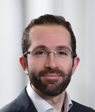 headshot of male with glasses smiling