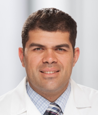 Male smiling in white lab coat