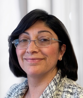 woman with glasses smiling headshot