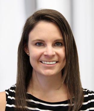 female in black and white shirt smiling headshot